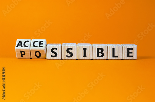 Possible and accessible symbol. Turned wooden cubes and changed the word possible to accessible. Business and possible or accessible concept. Beautiful orange background, copy space.