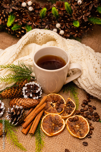  Beautiful stylish christmas composition with a cup of tea  cinnamon and pine cones 