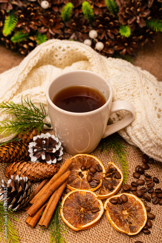 
Beautiful stylish christmas composition with a cup of tea, cinnamon and pine cones
