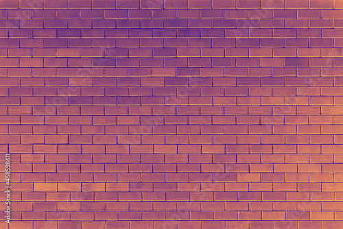 Purple and orange brick wall background at halloween evening.