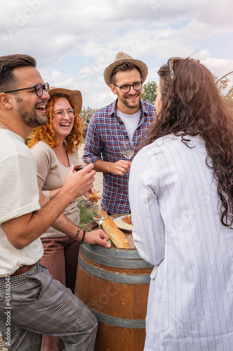 Canvas Print Happy friends having fun drinking wine at winery vineyard - Friendship concept w