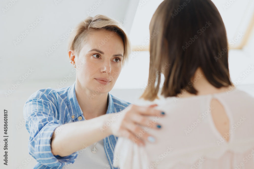a young and beautiful European woman psychologist or psychiatrist with short blonde hair conducts therapy with a client. mental health and mental support. psychologist or psychotherapist. emotions joy a young and beautiful European woman psychologist or psychiatrist with short blonde hair conducts therapy with a client. mental health and mental support. psychologist or psychotherapist. emotions joy
