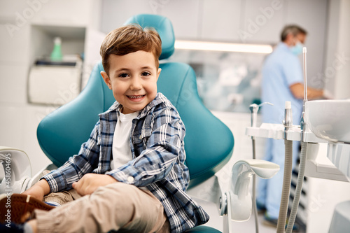 Happy little boy at dentist's office looking at camera.