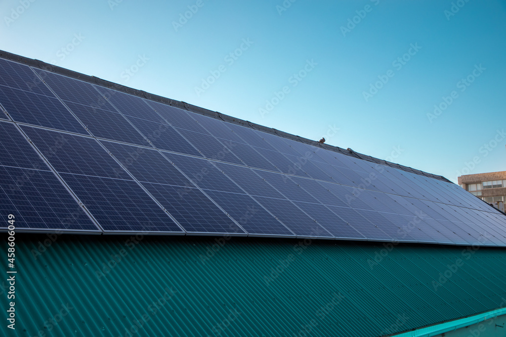 A Large amount of photovoltaic solar panels on a roof.
