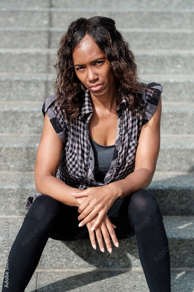 Mature black woman sitting on stairs. Mature black woman sitting on stairs.