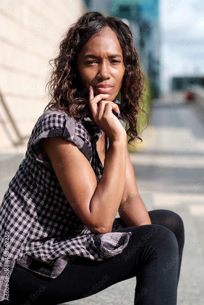 Mature black woman sitting on stairs and looking to camera. Mature black woman sitting on stairs and looking to camera.