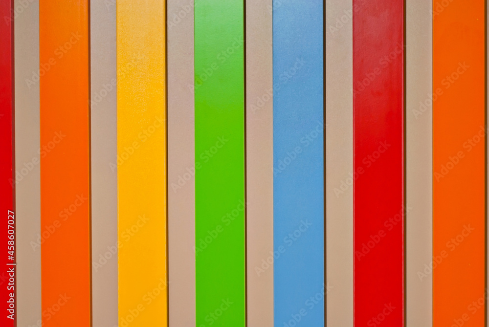 Multicolored strips of paper on the wall. Paper with rainbow colors. Interior design. Multicolored strips of paper on the wall. Paper with rainbow colors. Interior design.