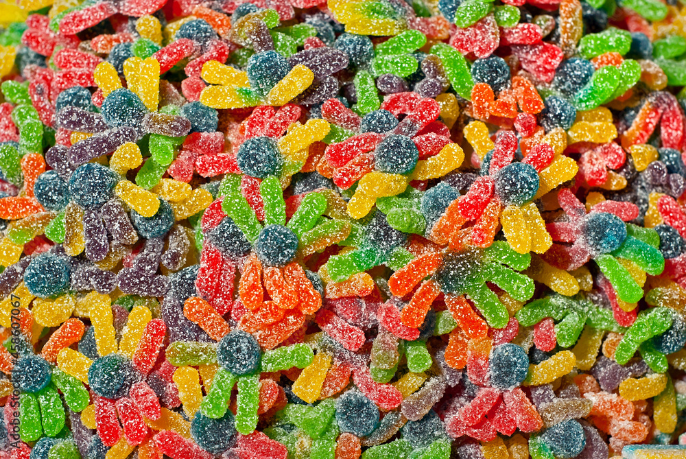 Texture of multicolored candies. Sweets on a pile close up. Sweets shop window.