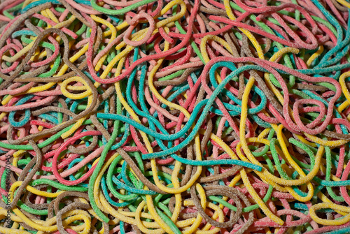 Texture of multicolored candies. Sweets on a pile close up. Sweets shop window.