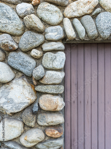 Rounded Fieldstone Wall and Bead Boaard Door photo