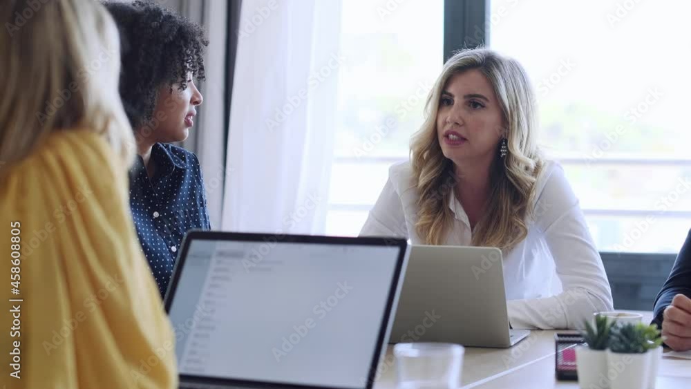 Video of multiage business people working with laptops while talking of they new project together in modern startup. Video of multiage business people working with laptops while talking of they new project together in modern startup.