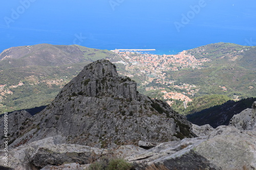 Elba, Italy – September 01, 2021: beautiful places from Elba Island. Aerial  view to the island. Little famous villages near the beaches. Summer tourist places. Clouds and blue sky in the background. © yohananegusse