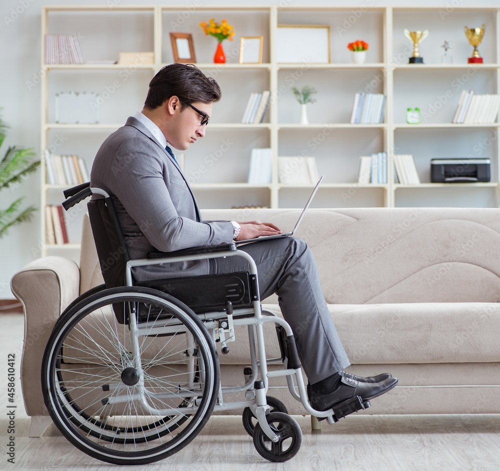Dsabled businessman on wheelchair working home Dsabled businessman on wheelchair working home