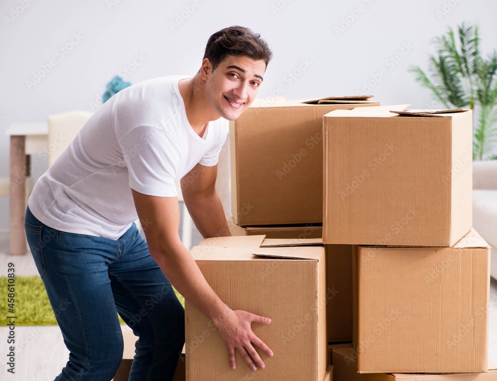 Young man moving boxes at home Young man moving boxes at home