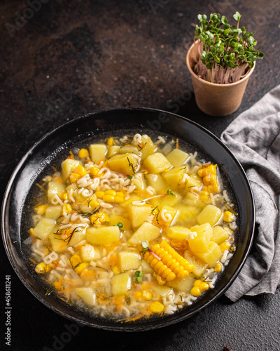 soup vegetable corn, potatoe, pasta alphabet, broth, chicken meat fresh portion meal snack on the table copy space food background rustic keto or paleo diet 