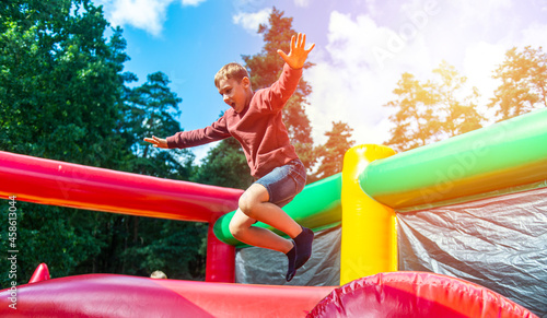 Canvastavla Child jumping on colorful playground trampoline