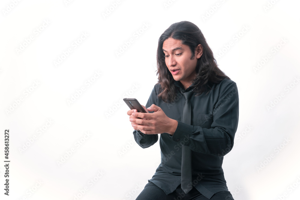Person with white background. He is looking at his cell phone, he is sending a text message. he is wearing formal clothes, he is working. White space. Man gesticulating. Person with white background. He is looking at his cell phone, he is sending a text message. he is wearing formal clothes, he is working. White space. Man gesticulating.