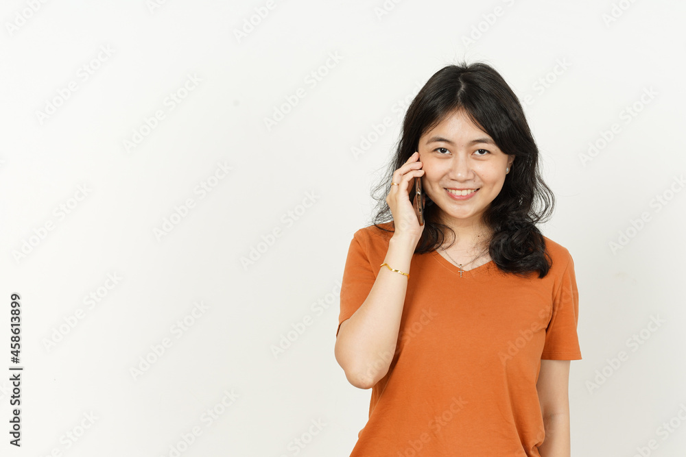 Talking on the phone with happy face expression of beautiful asian woman Wearing orange T-shirt isolated on white background Talking on the phone with happy face expression of beautiful asian woman Wearing orange T-shirt isolated on white background