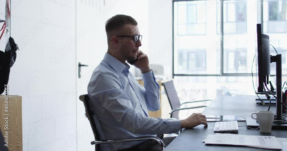 Caucasian graphic designer using electronic stylus for creating project calling to business partner for discussing ideas, formally dressed IT professional checking statistics while analyzing report
