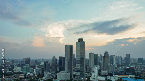 Aerial view of Asia Business concept for real estate - panoramic modern cityscape building bird eye aerial view under sunset and blue bright sky in Jakarta. Jakarta, Indonesia, September 23, 2021
