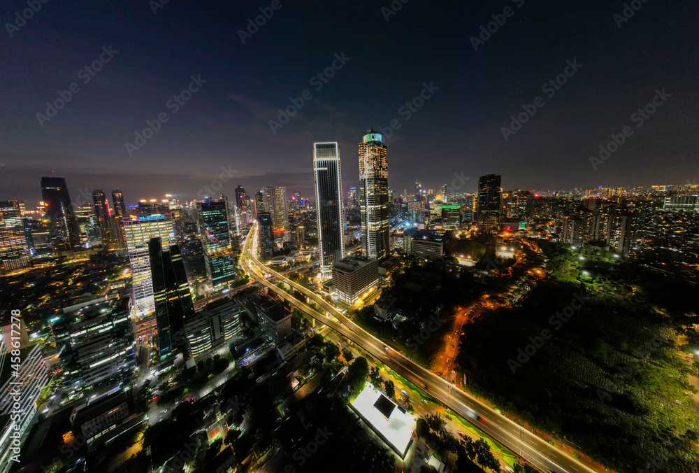 Aerial view of Architecture details Modern Building Glass facade Business background at night. Jakarta, Indonesia, September 23, 2021