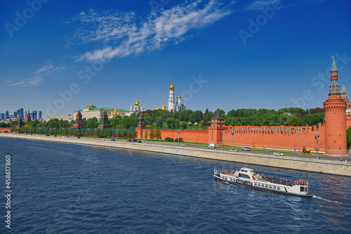 View of the Moscow Kremlin from the Moscow river. Red brick towers and Bell Tower Of Ivan The Great. Grand Kremlin palace. Travel to the capital of Russia. Moscow, Russia.