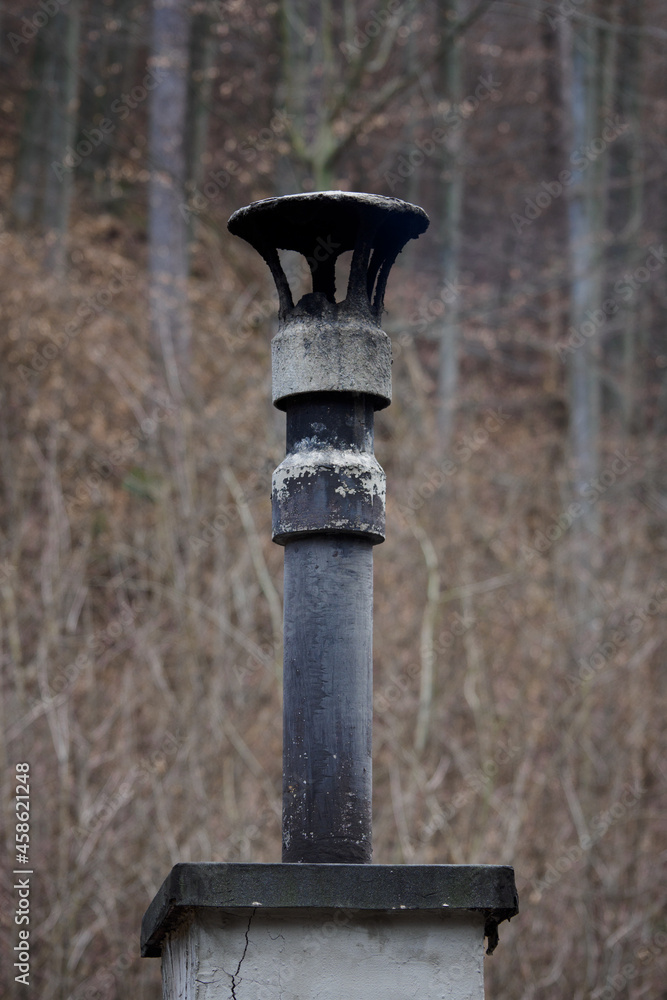 Chimney with pipes and an end in a mountain hut.