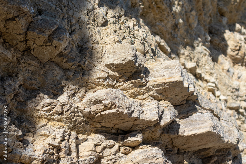White layered cliff rocks texture, geology close-up, coast of Lefkada island in Greece. Summer wild nature material surface close-up