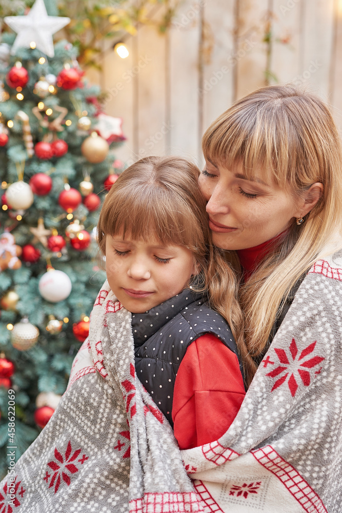 Mother and baby daughter near Christmas tree with gifts, Family Christmas in July. Winter holidays and people concept. Merry Christmas and Happy Holidays Greeting card. Mother and baby daughter near Christmas tree with gifts, Family Christmas in July. Winter holidays and people concept. Merry Christmas and Happy Holidays Greeting card.