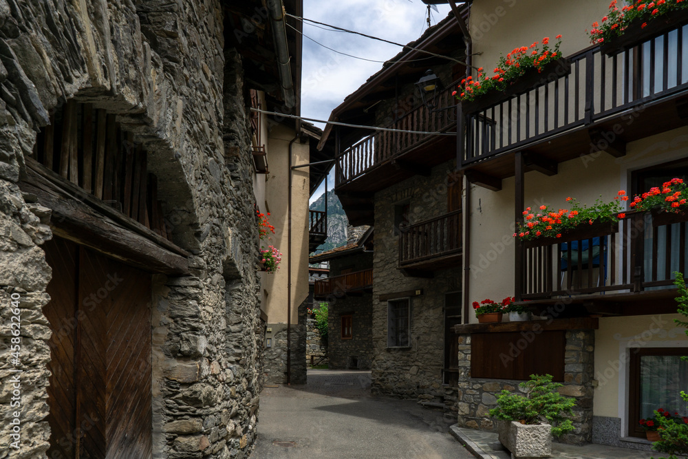 Old village with narrow cobblestone street and houses made of stone and wood