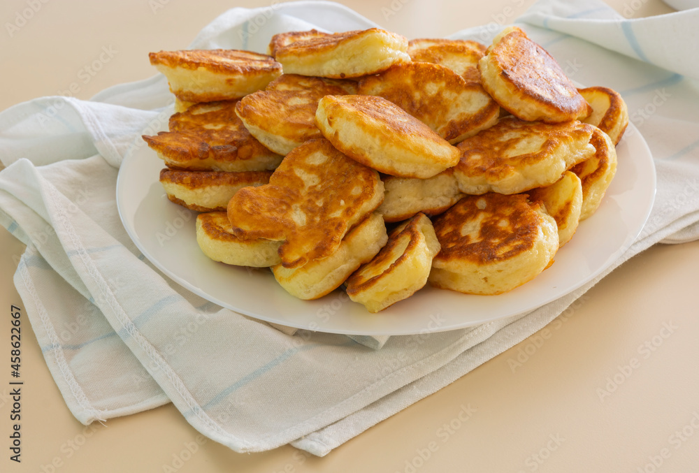 Freshly baked pancakes in a white plate on the table. Delicious morning breakfast with hot pancakes. homemade delicious fried Freshly baked pancakes in a white plate on the table. Delicious morning breakfast with hot pancakes. homemade delicious fried