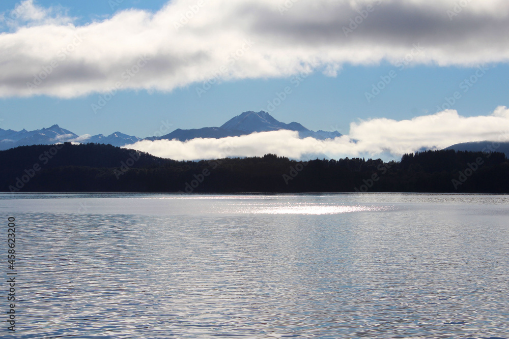 Panorama of Isla Victoria,  partly cloudy mountains.