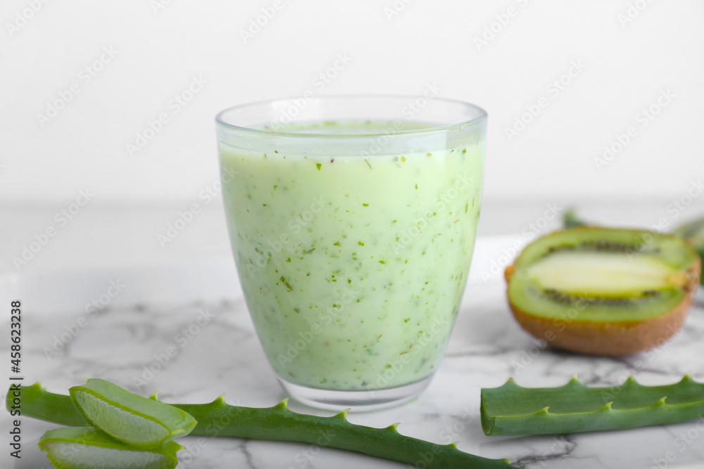 Tray with glass of healthy aloe juice on white background Tray with glass of healthy aloe juice on white background