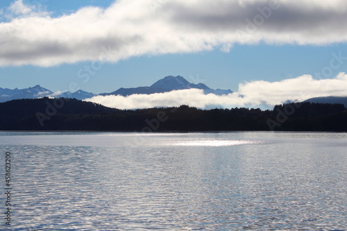 Panorama of Isla Victoria, partly cloudy mountains.
