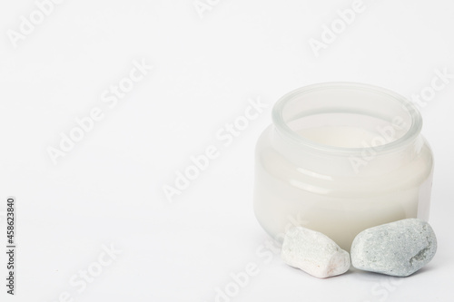 stones and a candle on a white background