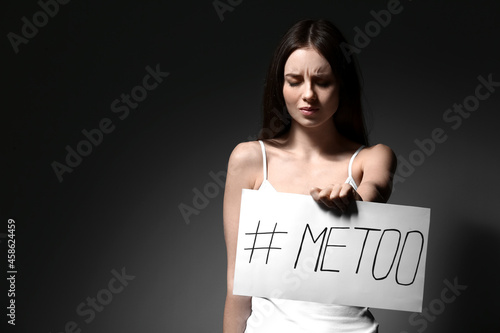 Young woman holding paper w...