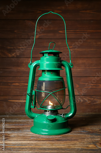 Green retro lamp on wooden ...