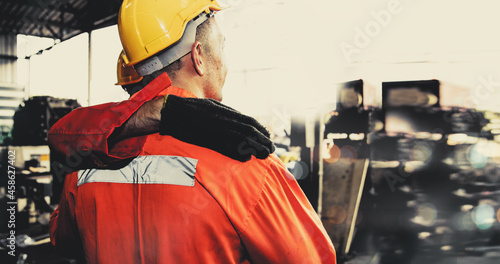 Fotografie Back view of engineers, machinists, factory workers working together looking at