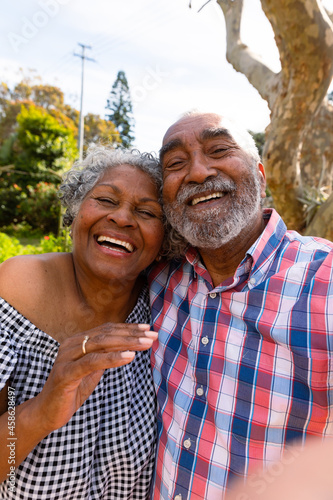 Happy african american senior couple taking selfie and hugging © wavebreak3