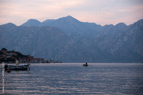Kotor / Montenegro - September 15 2021: View of a boat and the Kotor Bay at sunset, touristic famous destination in Montenegro, Europe © icephotography