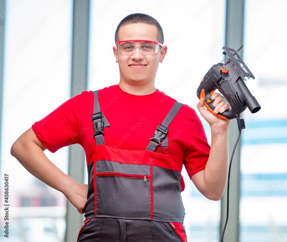 Young furniture carpenter in industrial concept Young furniture carpenter in industrial concept