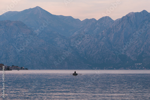 Kotor / Montenegro - September 15 2021: View of a boat and the Kotor Bay at sunset, touristic famous destination in Montenegro, Europe