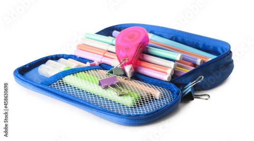 Opened pencil case with felt tip pens, corrector and paper clips on white background photo