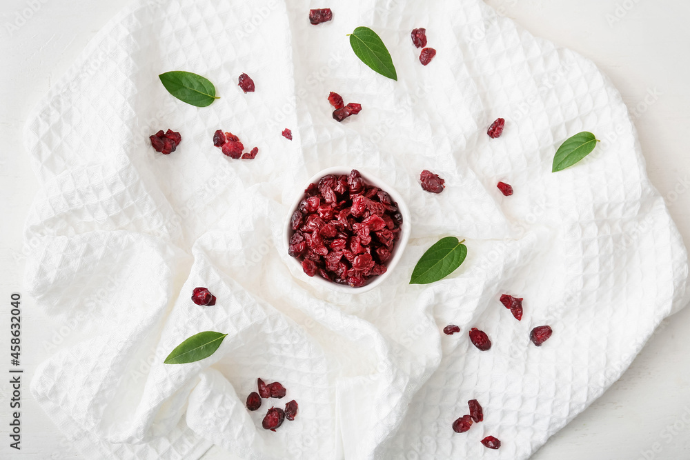 Bowl with tasty dried cranberries on light background Bowl with tasty dried cranberries on light background