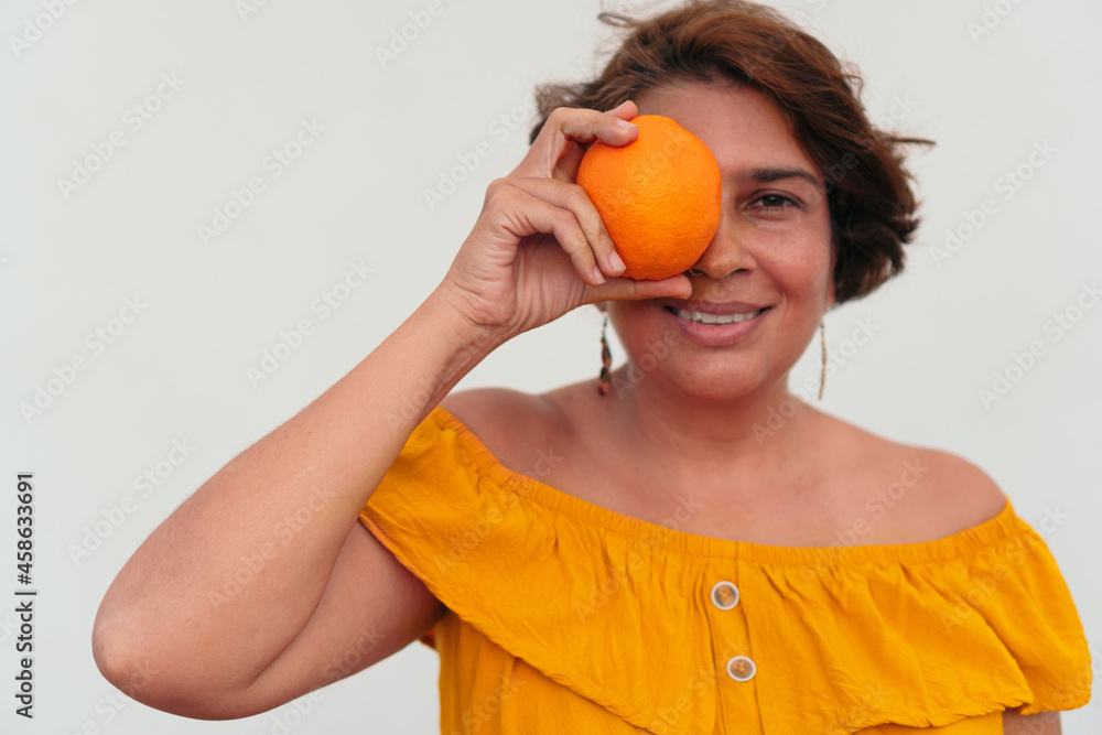 Portrait of a mature woman with an orange Portrait of a mature woman with an orange