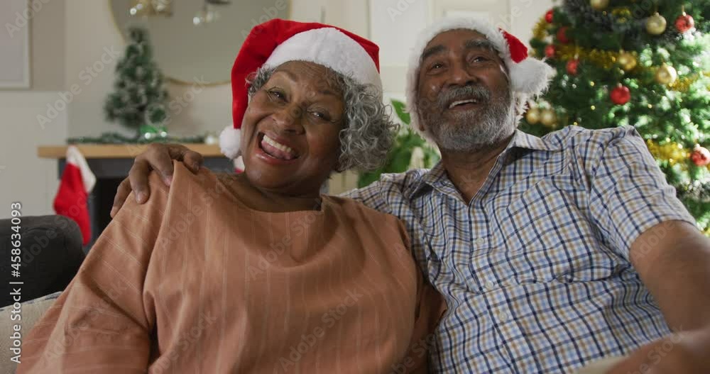 Animation of happy african american senior couple having video call at christmas time Animation of happy african american senior couple having video call at christmas time