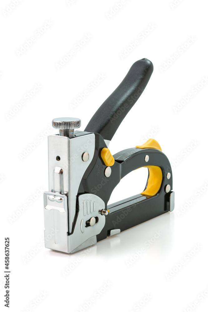 Construction stapler and staples isolated on white background. Heavy-duty steel staple gun to repairs or DIY around your home. Selective focus. Construction stapler and staples isolated on white background. Heavy-duty steel staple gun to repairs or DIY around your home. Selective focus.