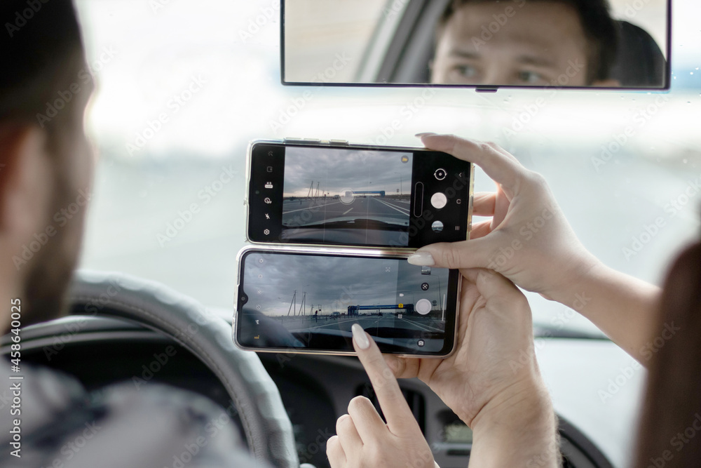 mobile phones in the hands of people in the car mobile phones in the hands of people in the car