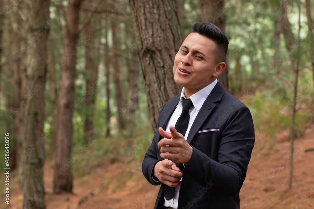 Man in an orange forest singing and pointing at the camera. Man in an orange forest singing and pointing at the camera.