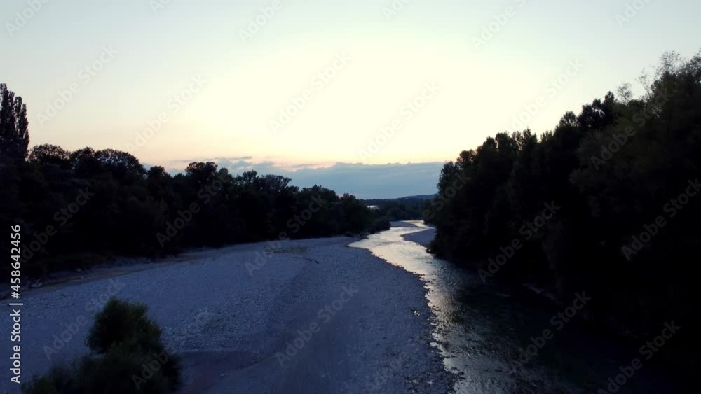 Rising Aerial over River Pebbles at Sunset Reveals Distant Mountains Rising Aerial over River Pebbles at Sunset Reveals Distant Mountains